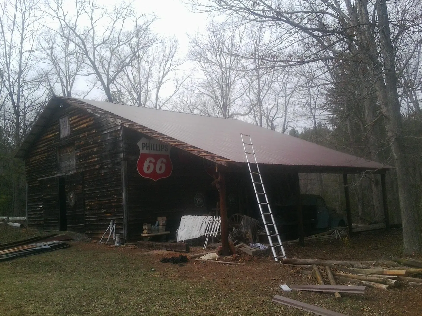 New metal roof on an open sided timber barn with a vintage sign in Dunn Loring